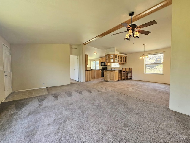 unfurnished living room featuring ceiling fan and light carpet