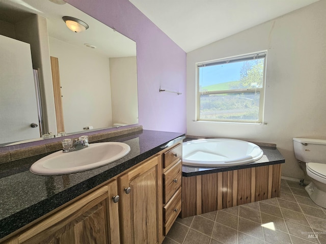 bathroom with vaulted ceiling, toilet, tile patterned floors, vanity, and a bath