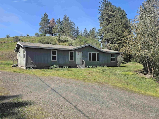 view of front of house with entry steps and a front lawn