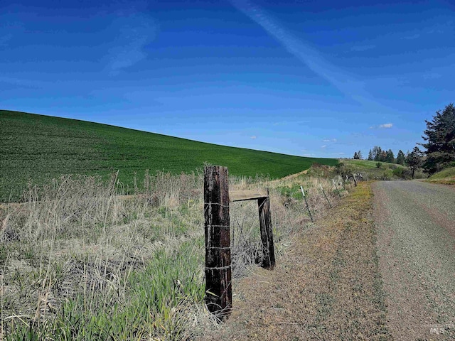 view of asphalt road with a view of rural / pastoral area