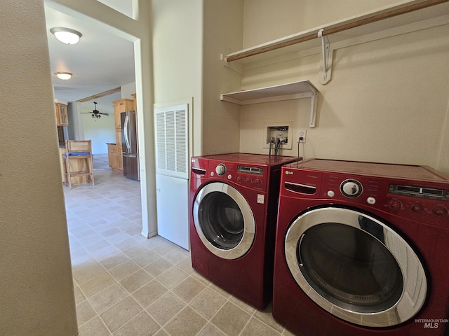 laundry area featuring washing machine and clothes dryer, a heating unit, a ceiling fan, and light tile patterned floors