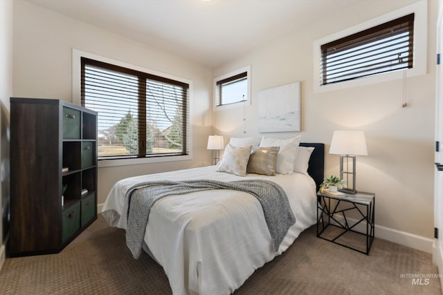 carpeted bedroom featuring baseboards