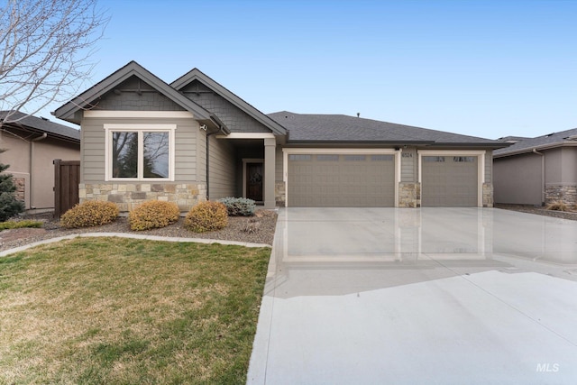 craftsman house with a front lawn, an attached garage, stone siding, and driveway