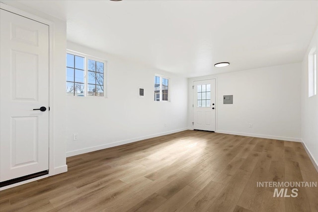 foyer entrance featuring hardwood / wood-style flooring and electric panel