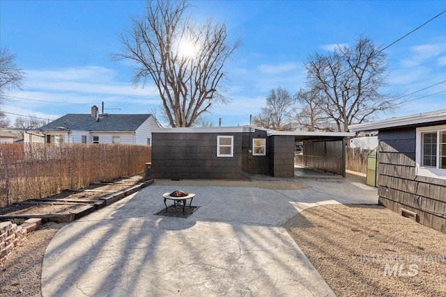 back of house with an outdoor fire pit