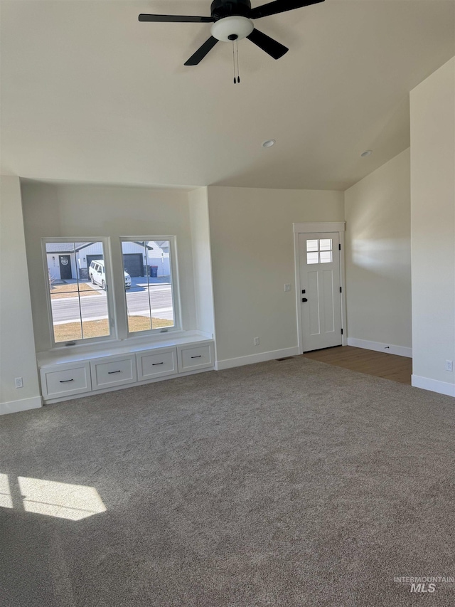 497 Jesse Ave, Twin Falls, ID 83301 - unfurnished living room with carpet floors, a ceiling fan, baseboards, and lofted ceiling