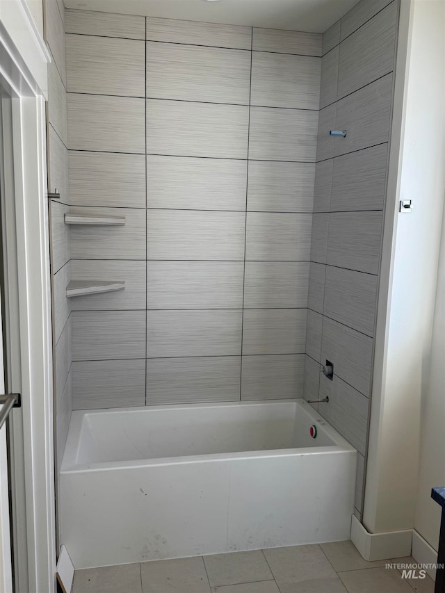 bathroom with tile patterned flooring and bathing tub / shower combination