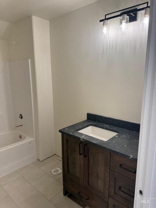 bathroom with washtub / shower combination, tile patterned floors, and vanity