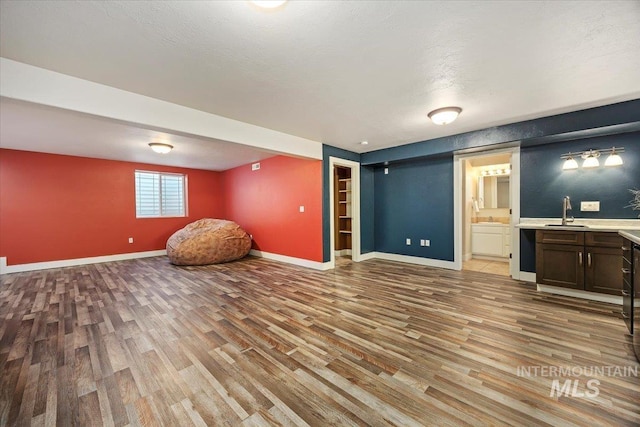 891 N Pointe Dr, Twin Falls, ID 83301 - unfurnished living room featuring wood finished floors, baseboards, and wet bar