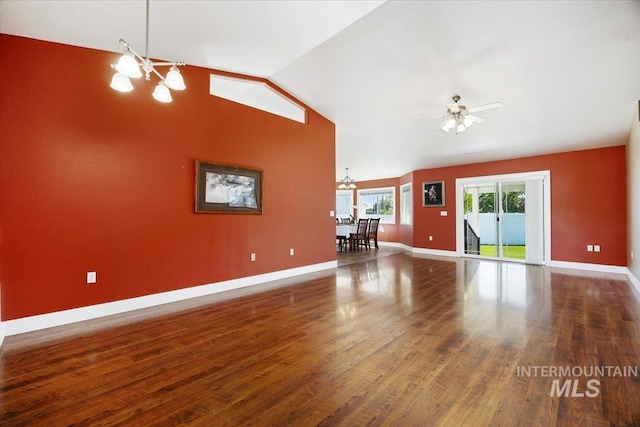 891 N Pointe Dr, Twin Falls, ID 83301 - unfurnished living room featuring a chandelier, baseboards, wood finished floors, vaulted ceiling, and a ceiling fan