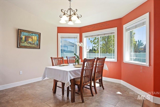 891 N Pointe Dr, Twin Falls, ID 83301 - dining area featuring a chandelier, baseboards, and tile patterned flooring