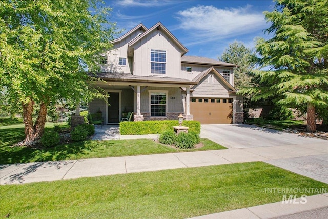 448 E Eaglewoods Ln, Eagle, ID 83616 - view of front of home featuring concrete driveway, a front lawn, a garage, a porch, and stone siding