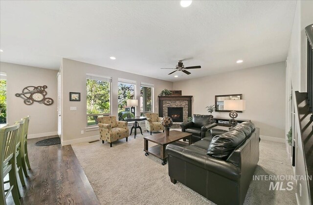 448 E Eaglewoods Ln, Eagle, ID 83616 - living room featuring a fireplace, healthy amount of natural light, ceiling fan, recessed lighting, and wood finished floors