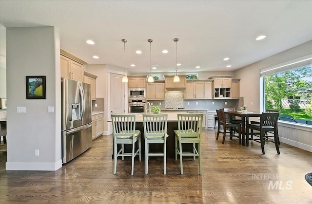 448 E Eaglewoods Ln, Eagle, ID 83616 - kitchen with stainless steel appliances, light countertops, a kitchen island with sink, dark wood-style flooring, and recessed lighting