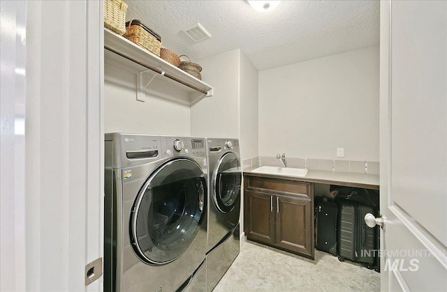 448 E Eaglewoods Ln, Eagle, ID 83616 - washroom featuring washer and dryer, cabinet space, and a textured ceiling