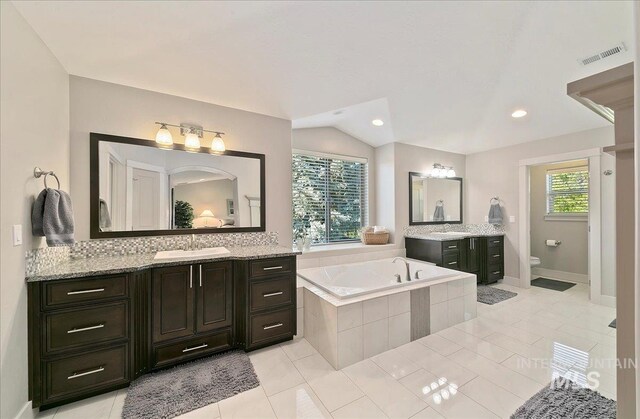 448 E Eaglewoods Ln, Eagle, ID 83616 - bathroom with a bath, two vanities, toilet, tile patterned floors, and recessed lighting