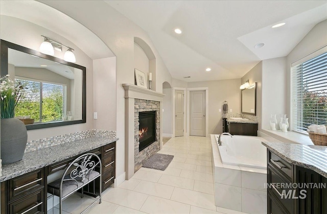 448 E Eaglewoods Ln, Eagle, ID 83616 - full bath with a garden tub, recessed lighting, a fireplace, tile patterned floors, and vaulted ceiling