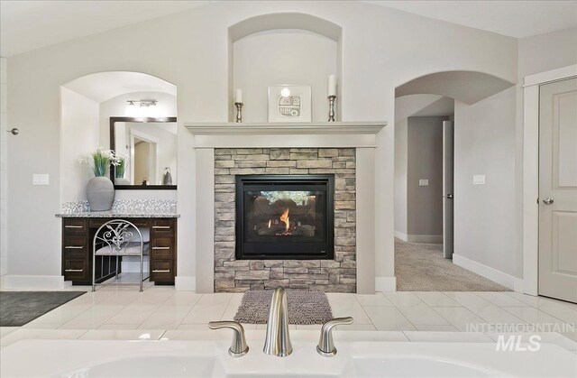 448 E Eaglewoods Ln, Eagle, ID 83616 - living room with a stone fireplace, baseboards, and carpet flooring