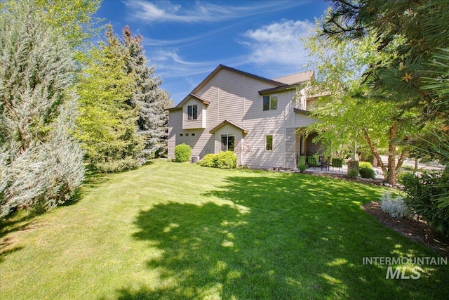 448 E Eaglewoods Ln, Eagle, ID 83616 - back of property featuring a lawn and an attached garage