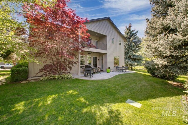 448 E Eaglewoods Ln, Eagle, ID 83616 - rear view of house featuring a balcony, a yard, and a patio