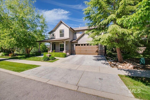 448 E Eaglewoods Ln, Eagle, ID 83616 - craftsman-style house featuring board and batten siding, concrete driveway, a garage, stone siding, and covered porch