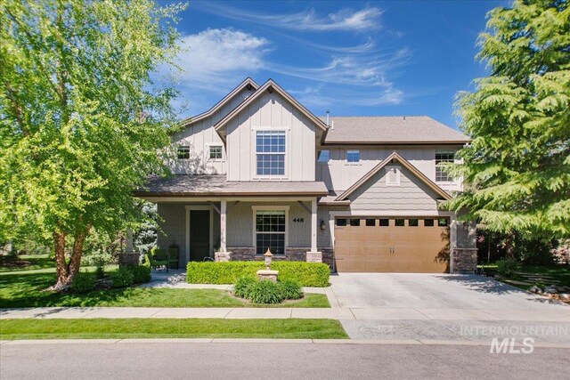 448 E Eaglewoods Ln, Eagle, ID 83616 - craftsman house with concrete driveway, stone siding, board and batten siding, a garage, and a porch