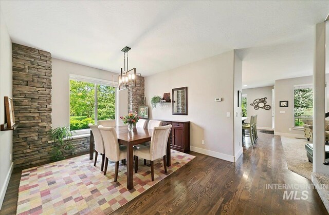 448 E Eaglewoods Ln, Eagle, ID 83616 - dining room with dark wood-style floors, a chandelier, and baseboards