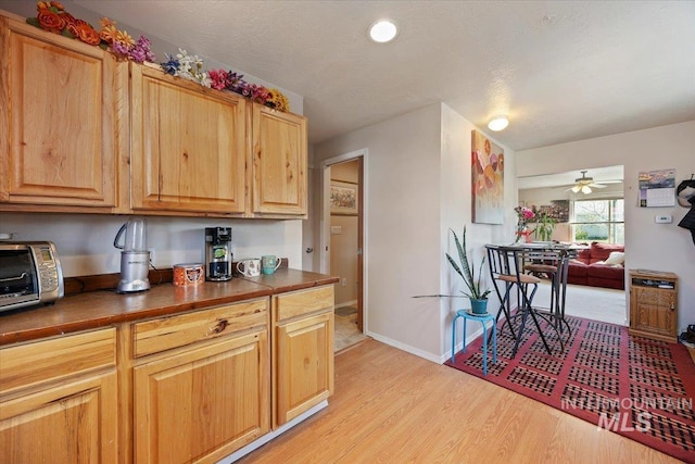 129 S Chestnut St, Kimberly, ID 83341 - kitchen featuring light wood-style flooring, dark countertops, baseboards, and ceiling fan