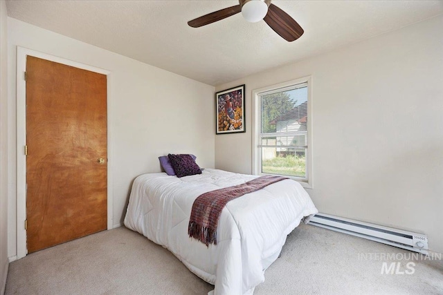 129 S Chestnut St, Kimberly, ID 83341 - bedroom with light carpet, a baseboard radiator, and ceiling fan