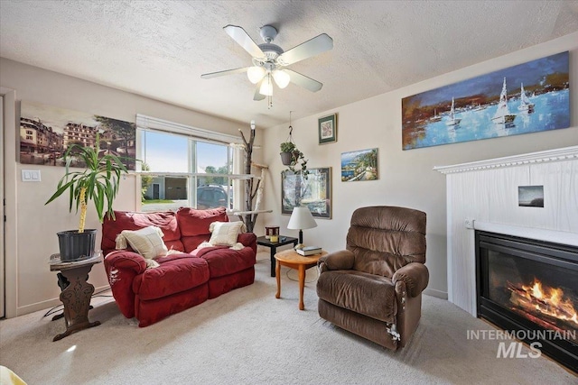 129 S Chestnut St, Kimberly, ID 83341 - carpeted living area featuring a textured ceiling, a ceiling fan, and a glass covered fireplace