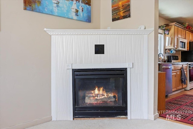 129 S Chestnut St, Kimberly, ID 83341 - detailed view of carpet flooring, white microwave, a glass covered fireplace, and stove