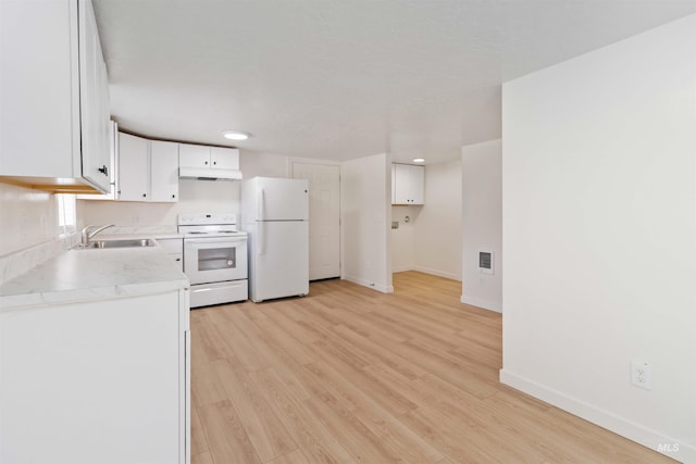 kitchen with baseboards, white cabinets, a sink, white appliances, and under cabinet range hood