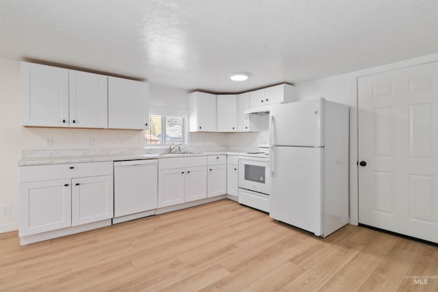 kitchen featuring white appliances, white cabinets, light countertops, a sink, and light wood finished floors