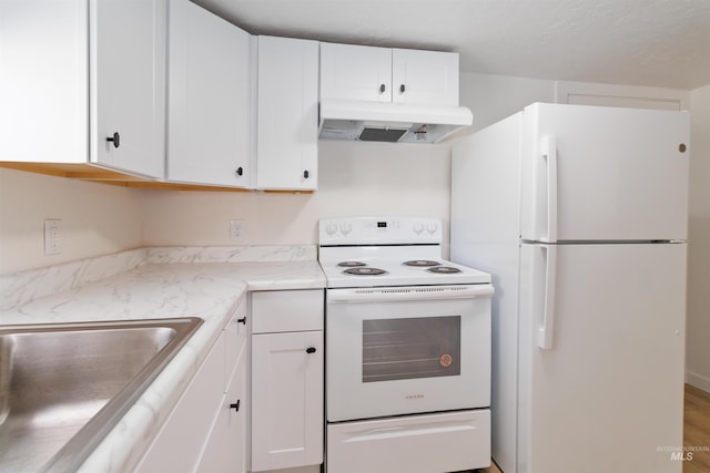 kitchen featuring white cabinets, under cabinet range hood, white appliances, and a sink