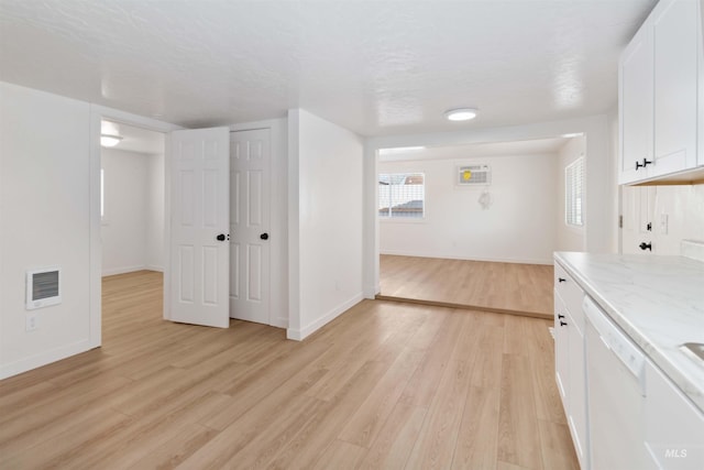 interior space featuring visible vents, baseboards, and light wood-style floors