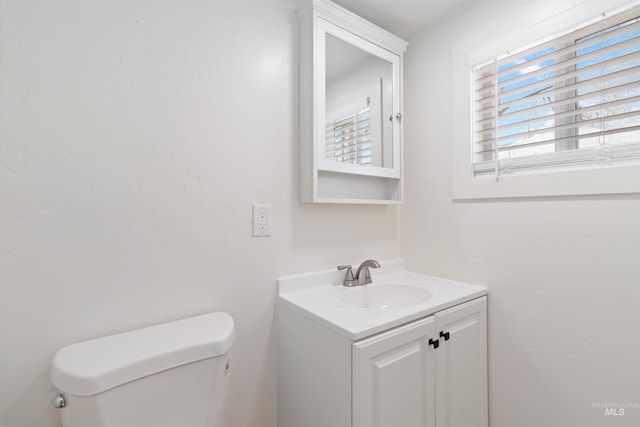 half bathroom featuring toilet and vanity