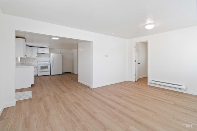 unfurnished living room with light wood-style flooring, a baseboard radiator, baseboards, and a sink