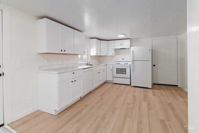 kitchen featuring white cabinets, light countertops, white appliances, under cabinet range hood, and light wood-style flooring