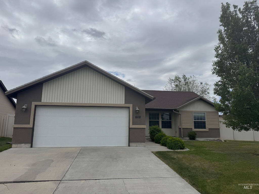 608 Heidi Ave, Twin Falls, ID 83301 - ranch-style house with concrete driveway, an attached garage, and a front lawn