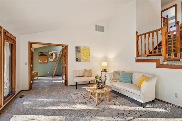 carpeted living room with lofted ceiling