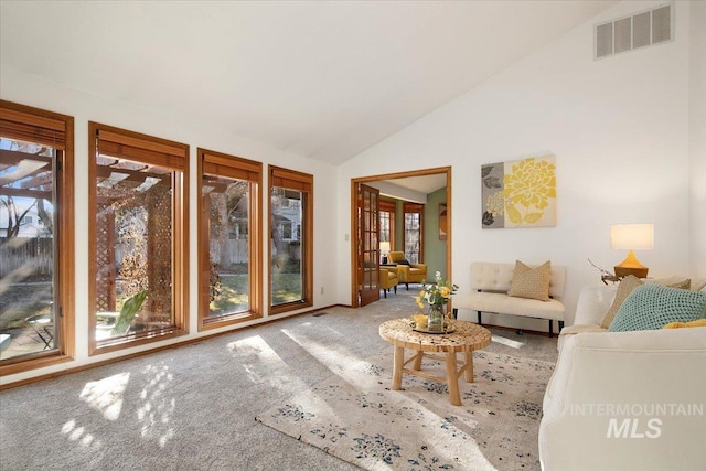 unfurnished living room featuring carpet flooring, french doors, and vaulted ceiling