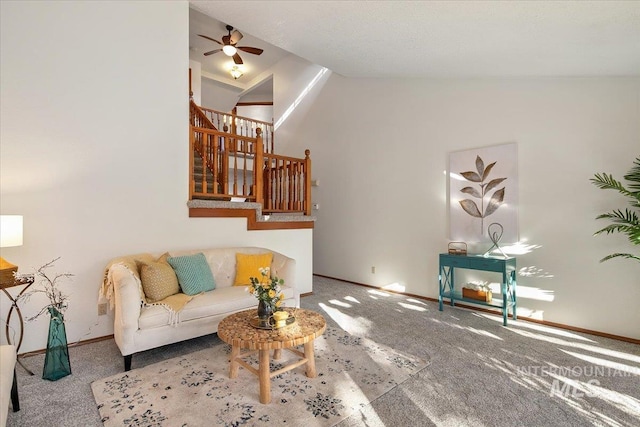 carpeted living room with vaulted ceiling and ceiling fan