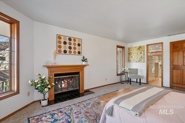 bedroom featuring carpet flooring and connected bathroom