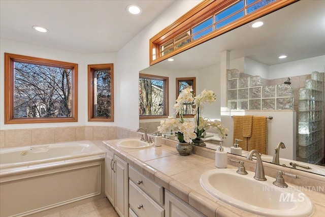 bathroom with a shower, vanity, and tile patterned floors