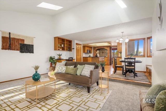 carpeted living room with a notable chandelier