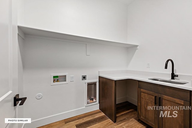 washroom featuring electric dryer hookup, light wood-style floors, laundry area, hookup for a washing machine, and a sink