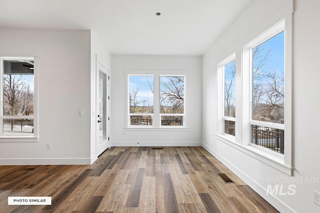 unfurnished sunroom featuring visible vents