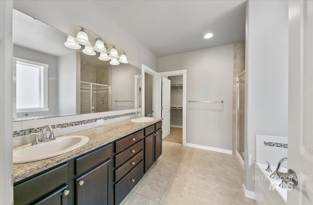 3225 N Quarrystone Way, Meridian, ID 83646 - full bathroom with a stall shower, a spacious closet, a bath, double vanity, and baseboards