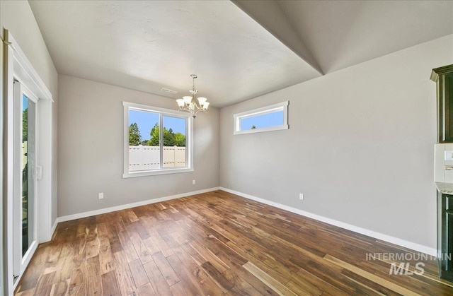 3225 N Quarrystone Way, Meridian, ID 83646 - empty room with a chandelier, baseboards, and hardwood / wood-style floors