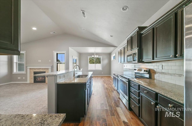 3225 N Quarrystone Way, Meridian, ID 83646 - kitchen with stainless steel appliances, a sink, lofted ceiling, a chandelier, and baseboards
